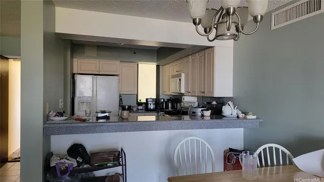 a bathroom with a two sinks a mirror and a lamp