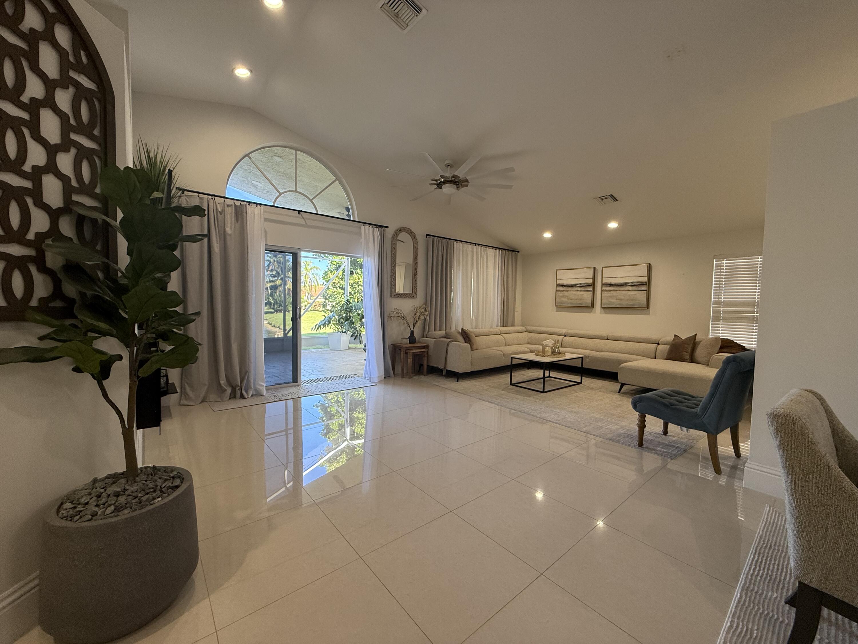 5325 Bodega Place Delray Beach, FL 33484 - Photo 11 of 40 a living room with furniture a window and a potted plant