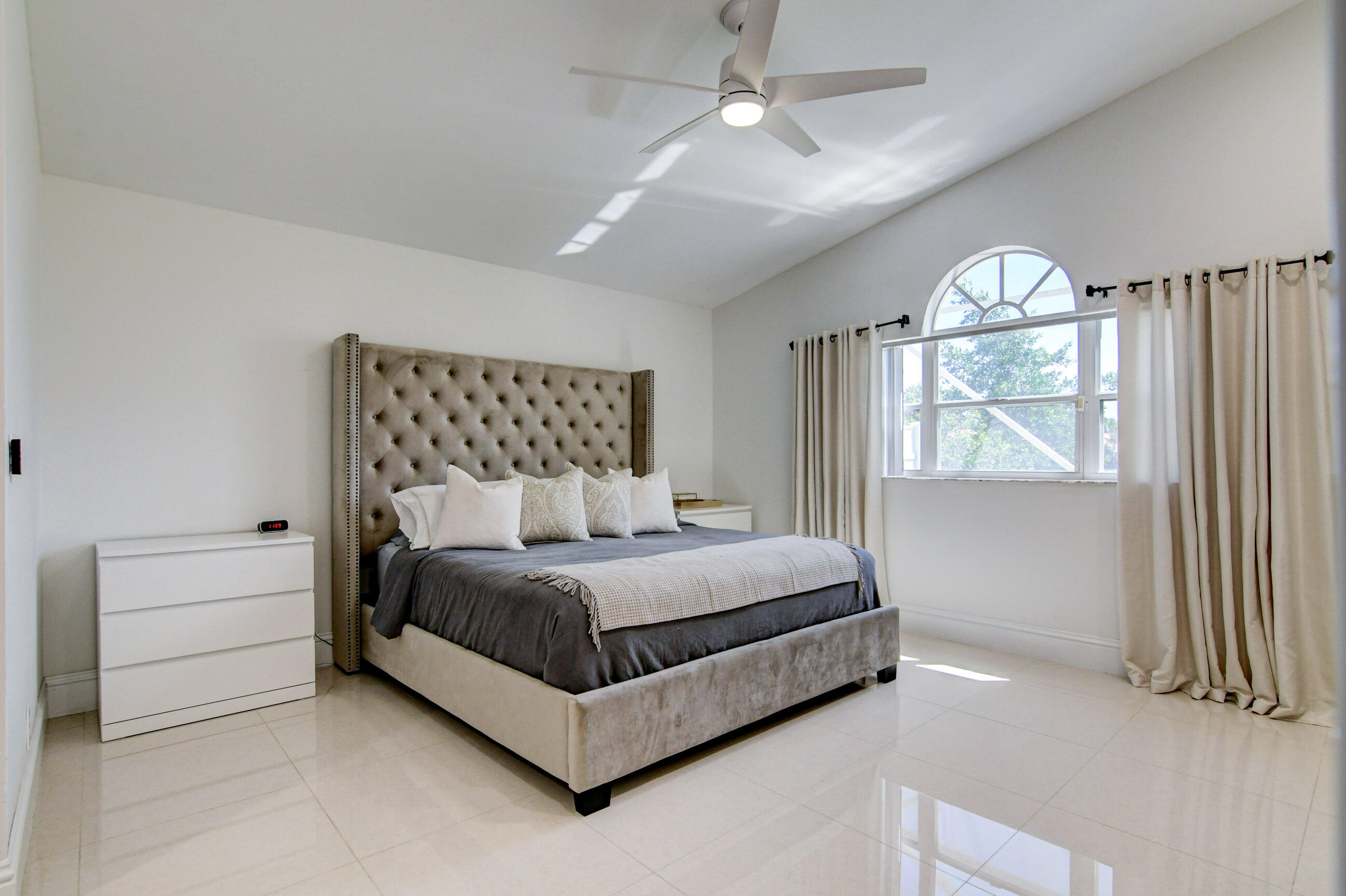 5325 Bodega Place Delray Beach, FL 33484 - Photo 15 of 40 a bedroom with a large bed and a chandelier