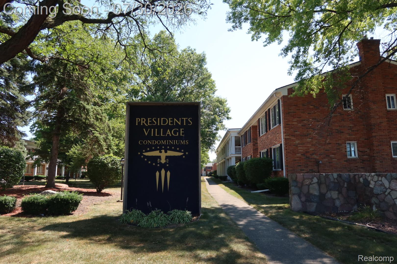 29232 Hoover Road, Unit 232 Warren, MI 48093 - Photo 1 of 22 Entrance sign for Presidents Village Condominiums featuring gold lettering and emblem