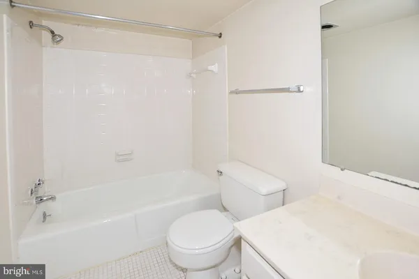 a bath room with a toilet and a bath tub