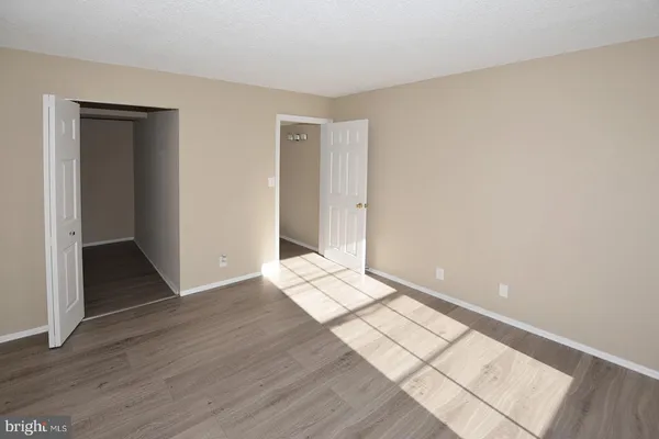 a view of an empty room and wooden floor