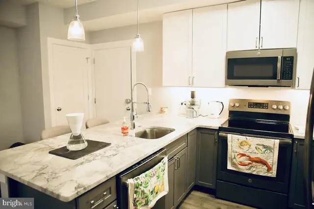 a kitchen with a sink a microwave a stove and refrigerator