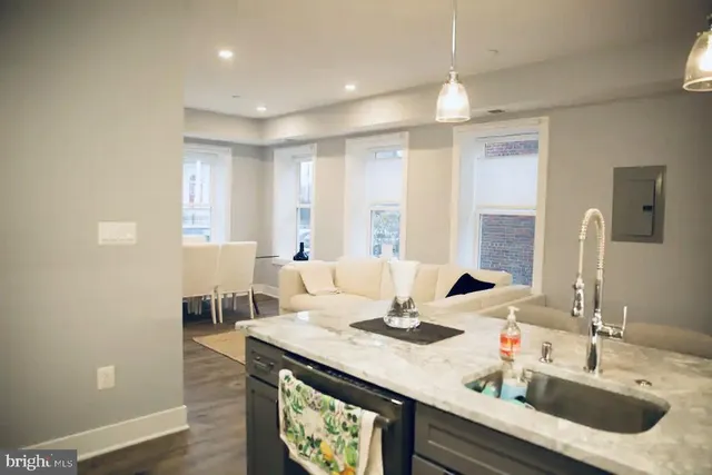 a kitchen with a stove a sink and a refrigerator
