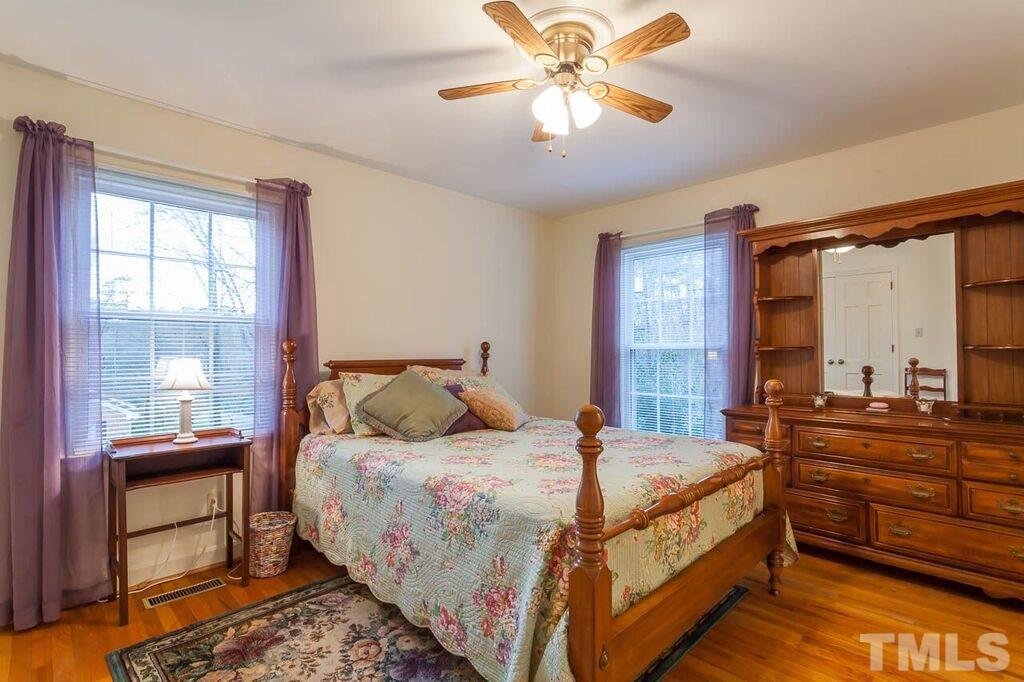 2903 Buckingham Road Durham, NC 27707 - Photo 12 of 15 a bedroom with a bed and a chandelier