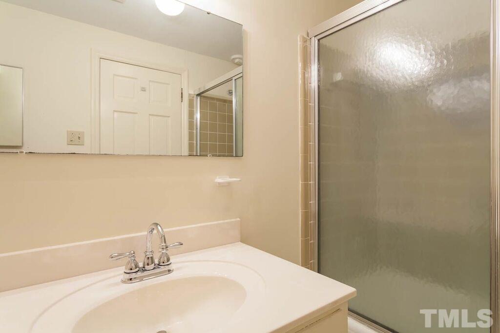 2903 Buckingham Road Durham, NC 27707 - Photo 14 of 15 a bathroom with a sink and a mirror