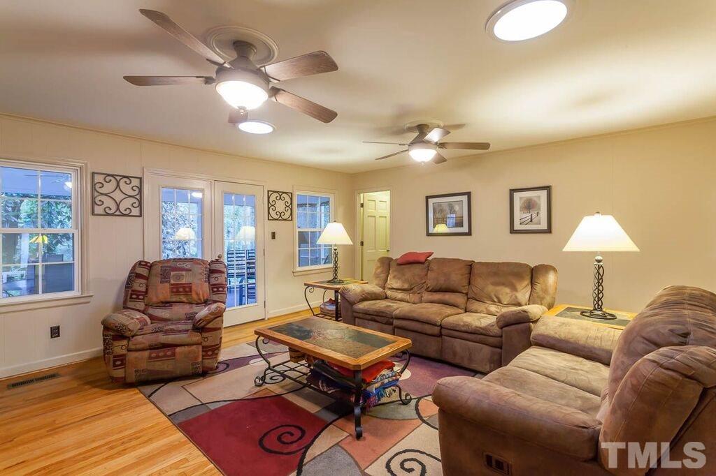 2903 Buckingham Road Durham, NC 27707 - Photo 7 of 15 a living room with furniture a chandelier fan and a window