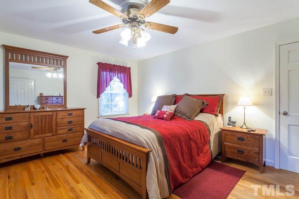 2903 Buckingham Road Durham, NC 27707 - Photo 10 of 15 a bedroom with a bed and a chandelier