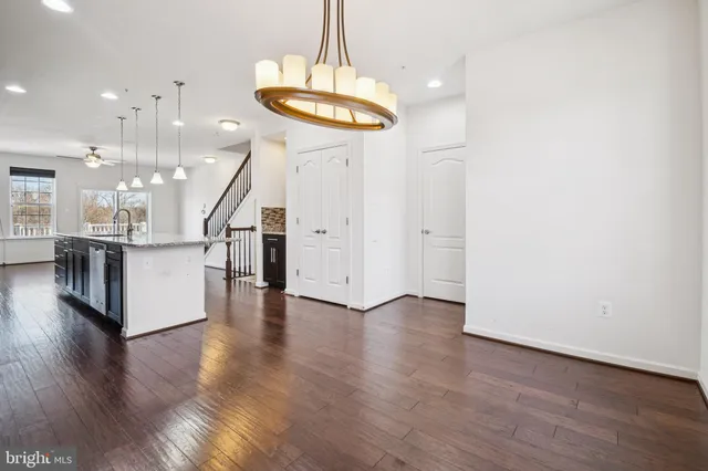 wooden floor in an empty room with a kitchen