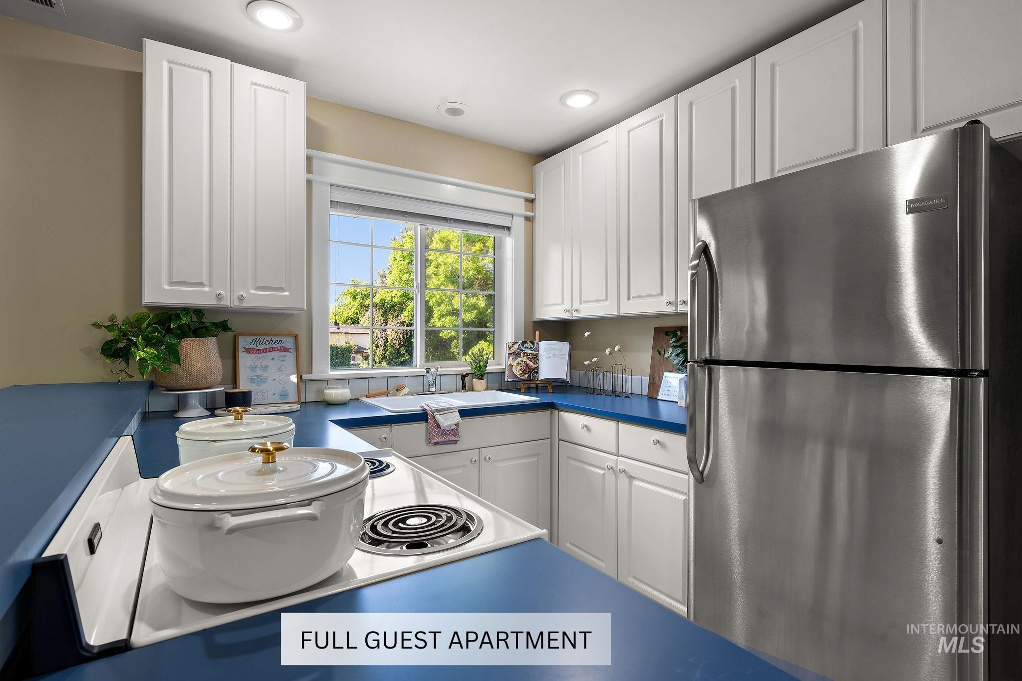 515 North Sierra View Way Eagle, ID 83616 - Photo 33 of 50 Kitchen featuring freestanding refrigerator, white cabinets, recessed lighting, and dark countertops