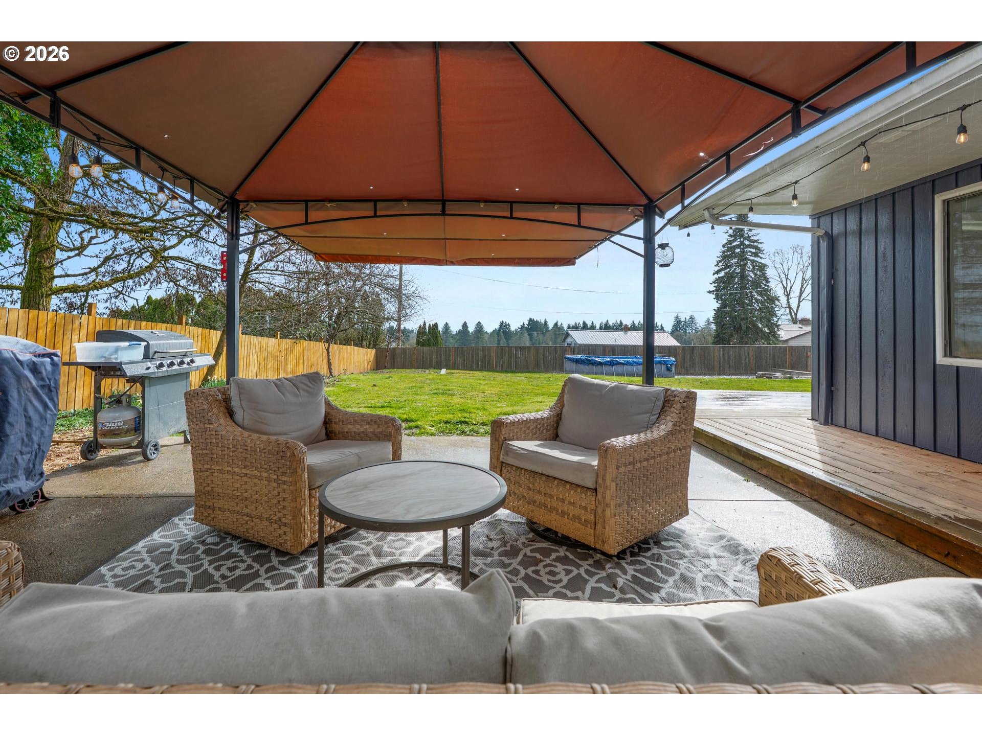 35254 Pittsburg Road St. Helens, OR 97051 - Photo 27 of 38 a view of a patio with couches table and chairs under an umbrella