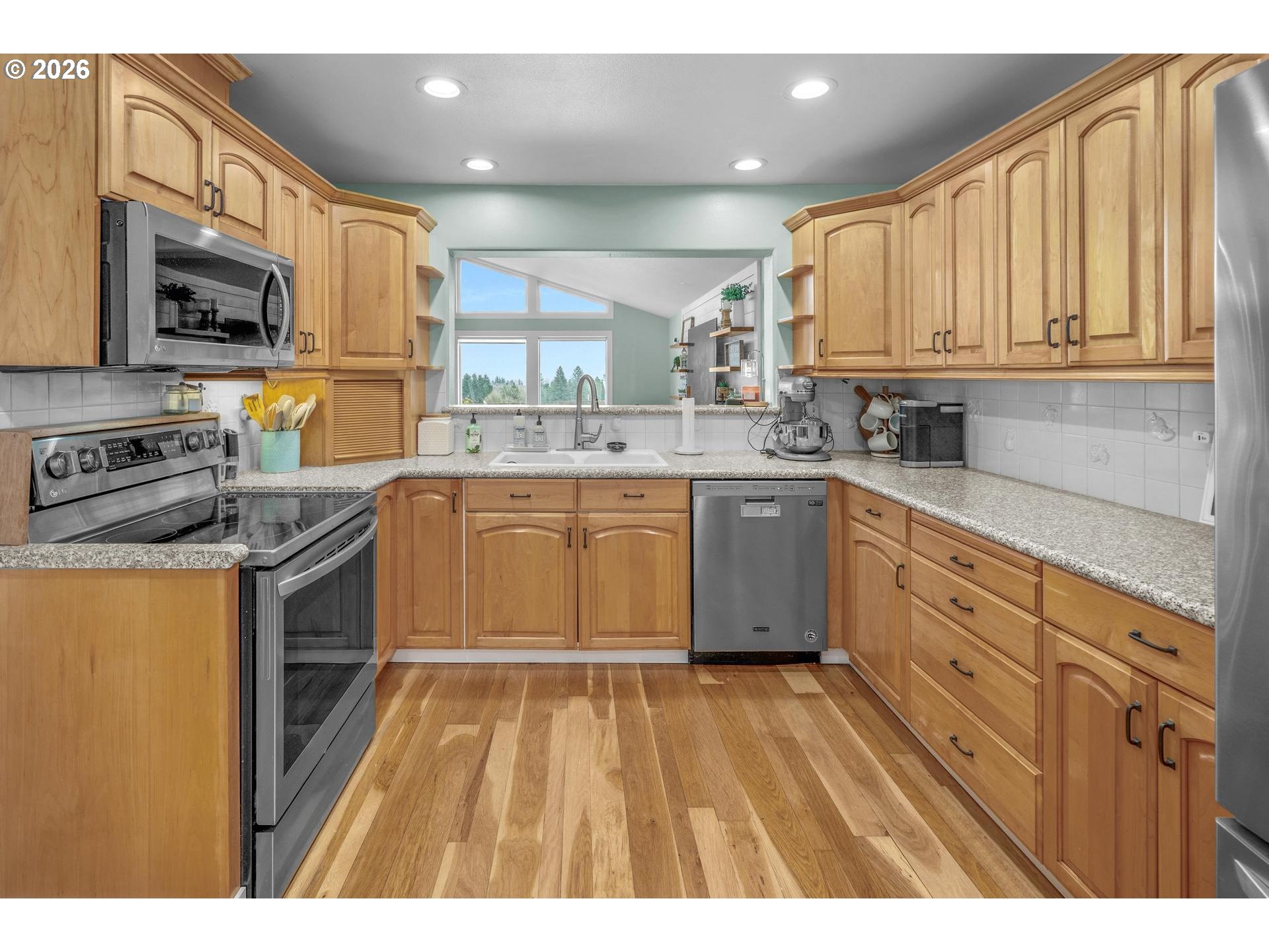 35254 Pittsburg Road St. Helens, OR 97051 - Photo 10 of 38 a kitchen with stainless steel appliances granite countertop a sink a stove cabinets and a refrigerator