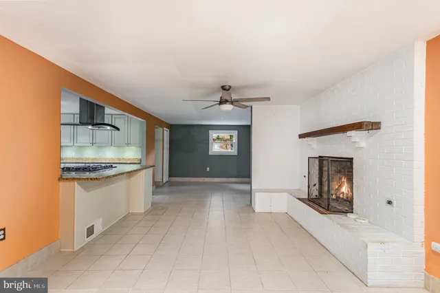 a large kitchen with a sink and a stove top oven