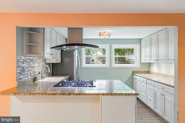 a kitchen with stainless steel appliances granite countertop a sink and cabinets