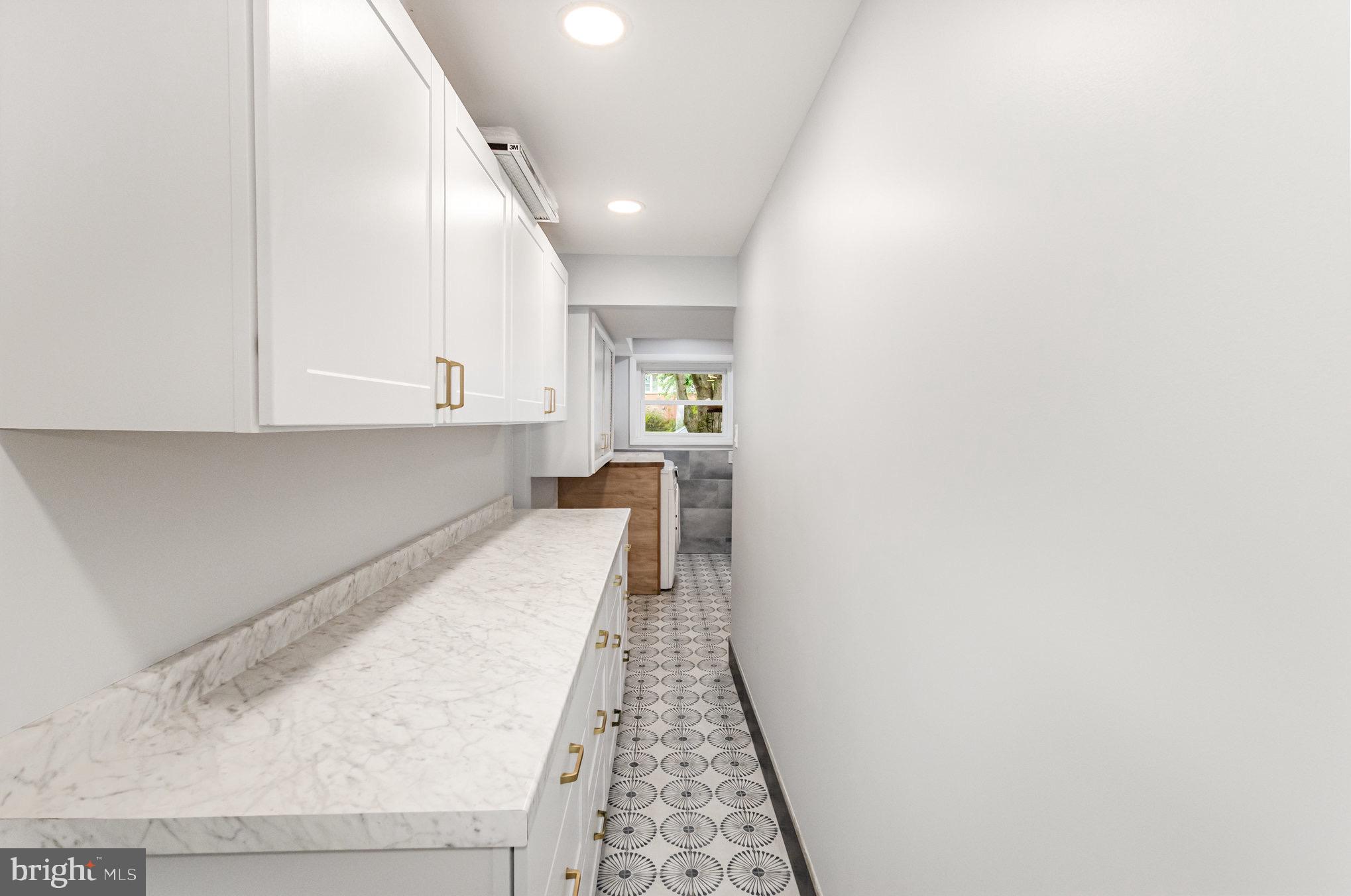309 Williamsburg Road Sterling, VA 20164 - Photo 18 of 30 a hallway with white cabinets and wooden floor