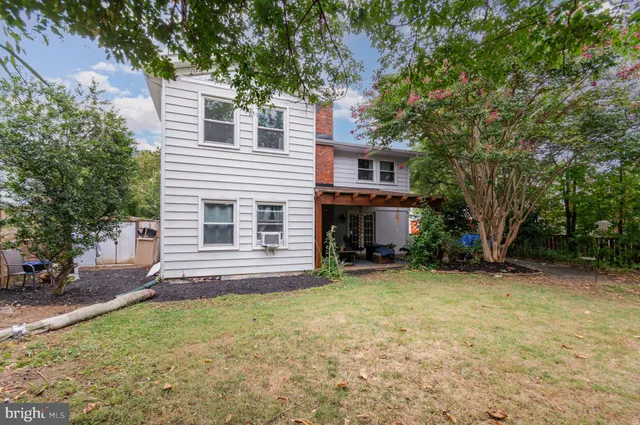 a view of a house with a yard and tree s