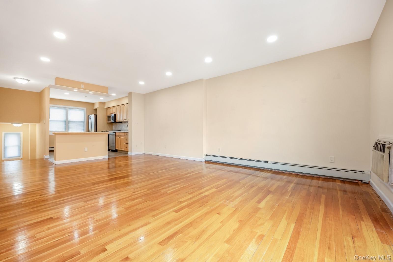 69-05 61st Road Queens, NY 11379 - Photo 13 of 31 a view of empty room with wooden floor