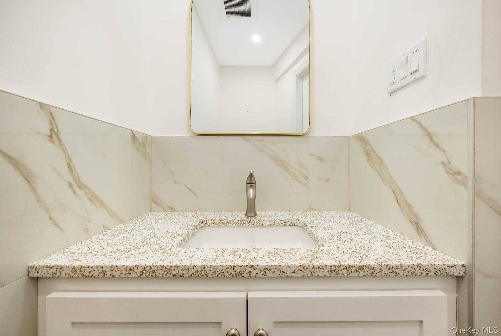 69-05 61st Road Queens, NY 11379 - Photo 15 of 31 a bathroom with a granite countertop sink and a mirror