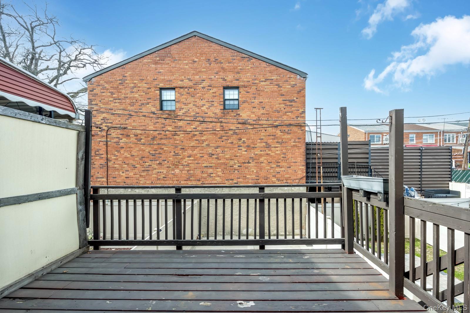 69-05 61st Road Queens, NY 11379 - Photo 16 of 31 a view of a balcony with wooden floor