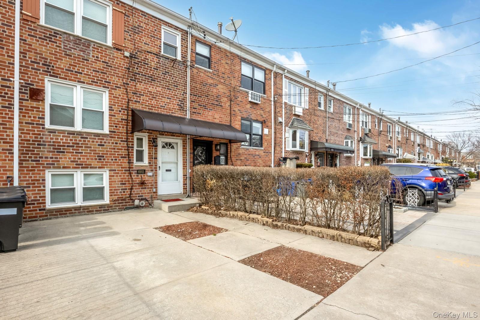 69-05 61st Road Queens, NY 11379 - Photo 2 of 31 a front view of a building with cars