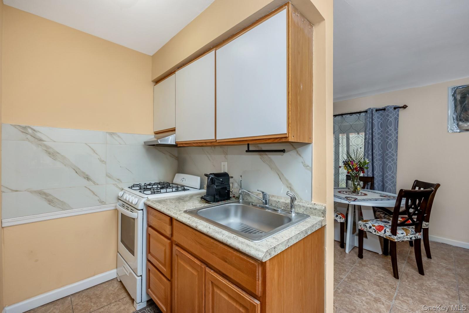 69-05 61st Road Queens, NY 11379 - Photo 24 of 31 a kitchen with stainless steel appliances granite countertop a sink stove and cabinets