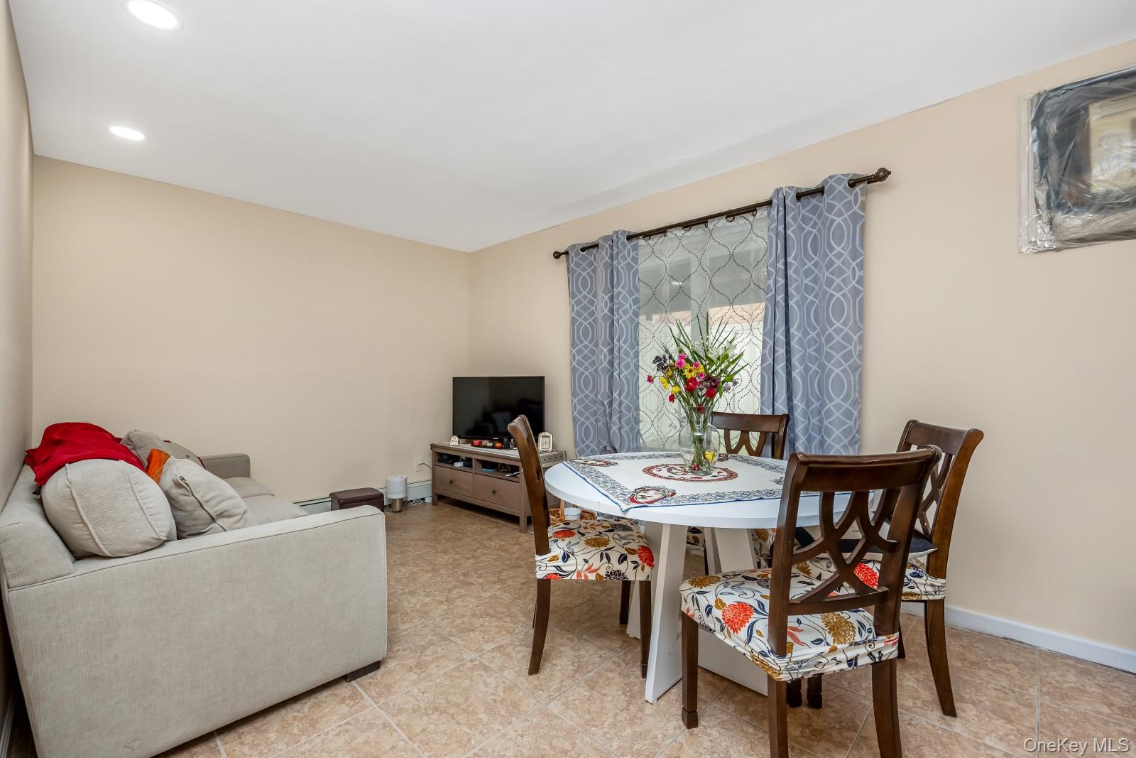 69-05 61st Road Queens, NY 11379 - Photo 25 of 31 a view of a dining room with furniture and window
