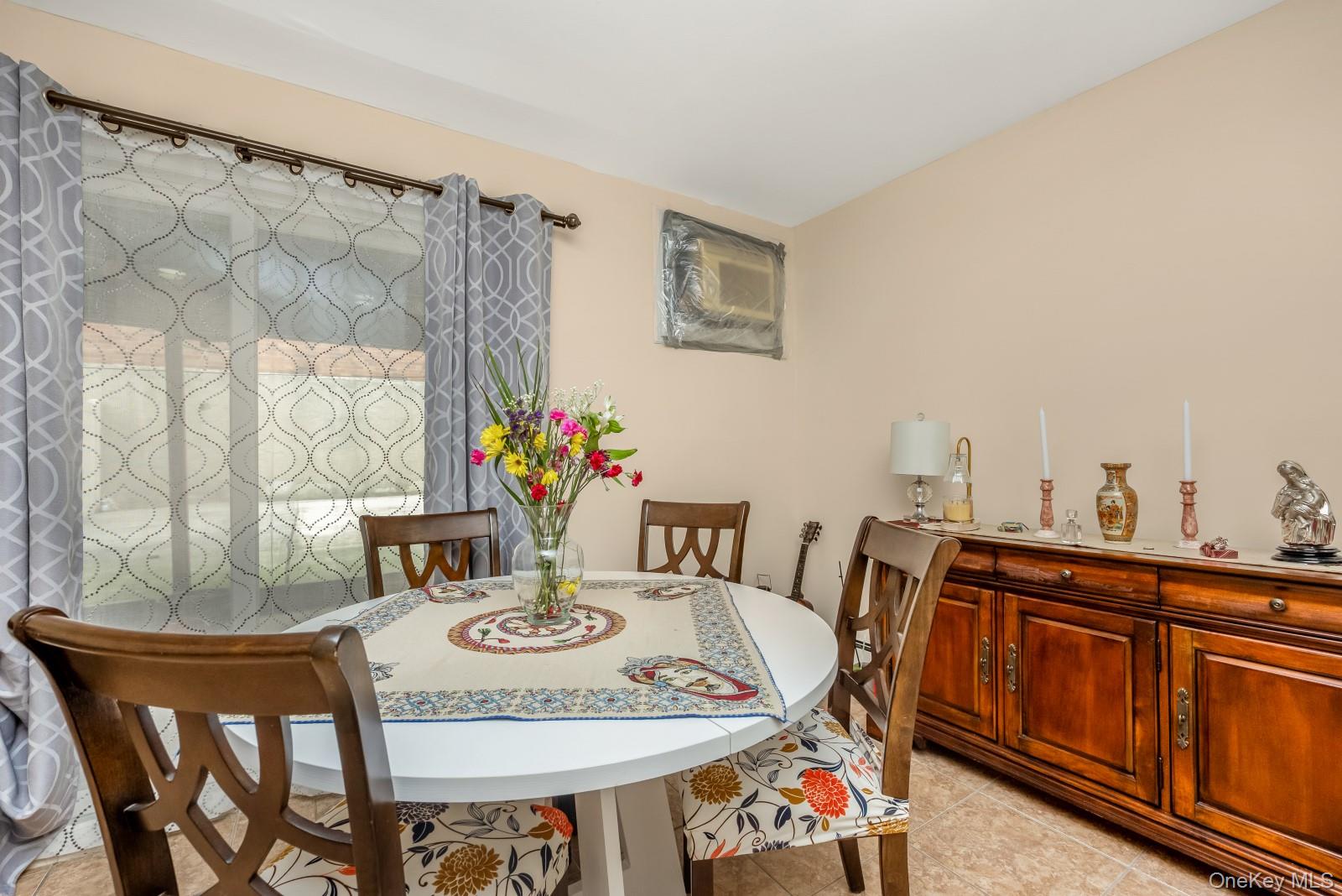 69-05 61st Road Queens, NY 11379 - Photo 26 of 31 a view of a dining room with furniture and window