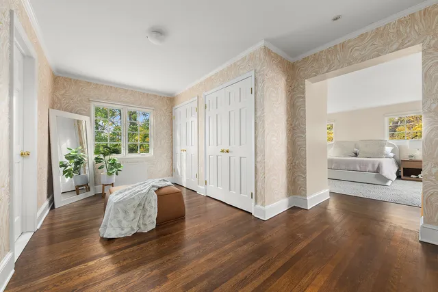 a spacious bedroom with a bed and a couch