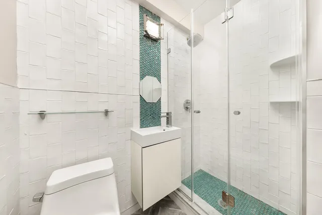 an empty room with wooden floor a exposed radiator and windows
