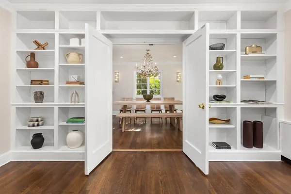 a view of living room with cabinets and wooden floor