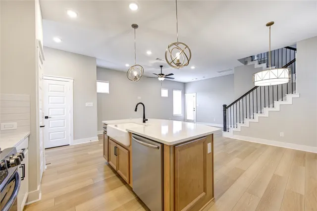 a kitchen with a stove cabinets and wooden floor