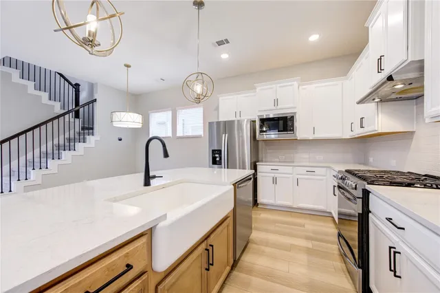 a kitchen with cabinets appliances and a counter top