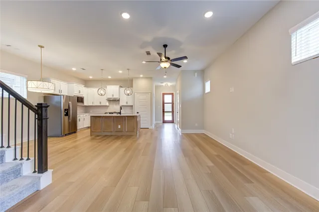 a view of a kitchen with a sink and a refrigerator