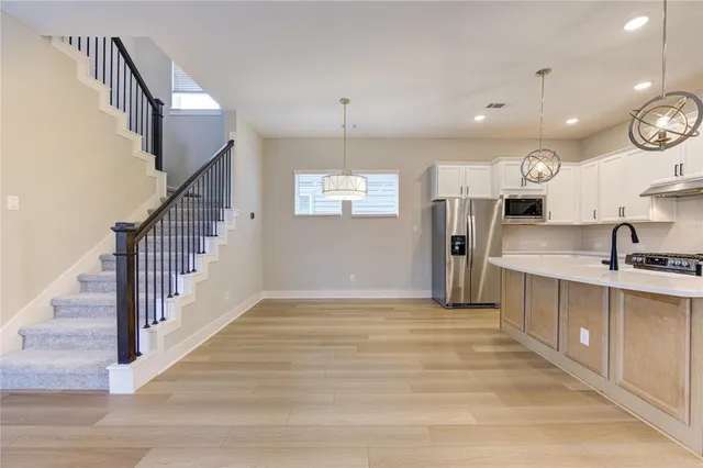 a view of a kitchen with a sink and cabinets