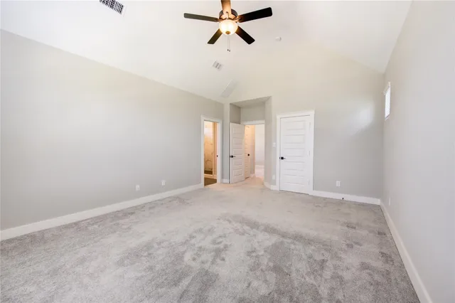 an empty room with closet and windows