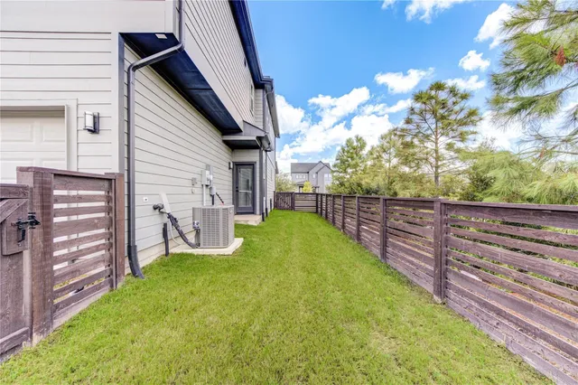 a view of a backyard with wooden fence