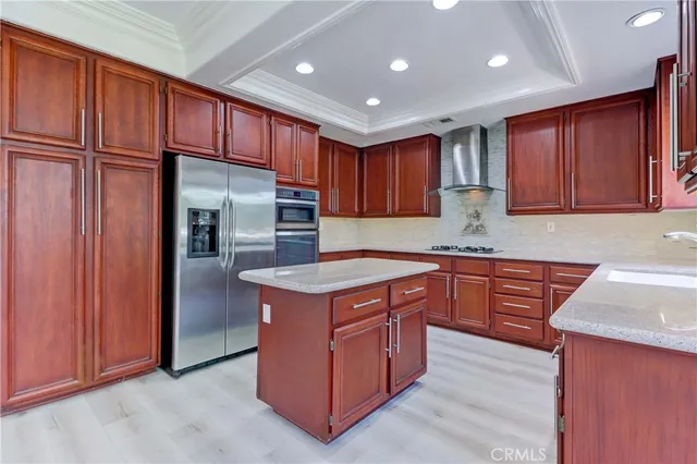 a kitchen with stainless steel appliances granite countertop wooden cabinets a sink and dishwasher a refrigerator with wooden cabinets