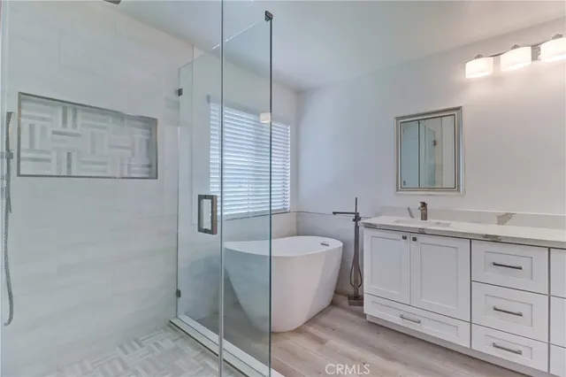 a bathroom with a tub sink and mirror