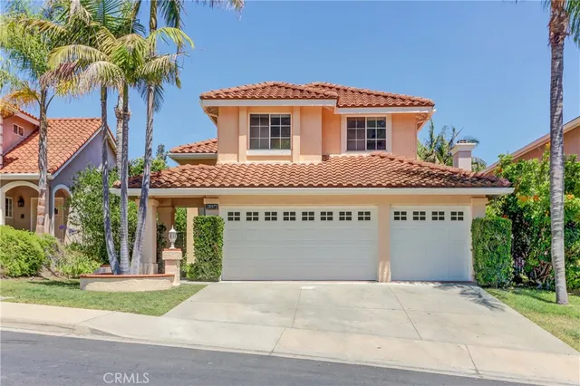 a front view of house with yard and trees