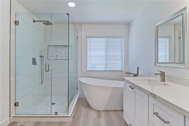 a white bath tub sitting next to a white sink