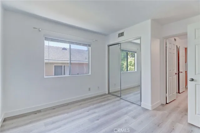a spacious bathroom with a double vanity sink a mirror and a shower
