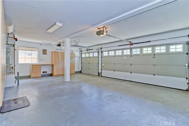 a front view of a house with a garden and a garage