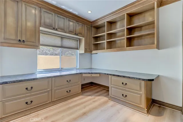 a kitchen with granite countertop white cabinets and window