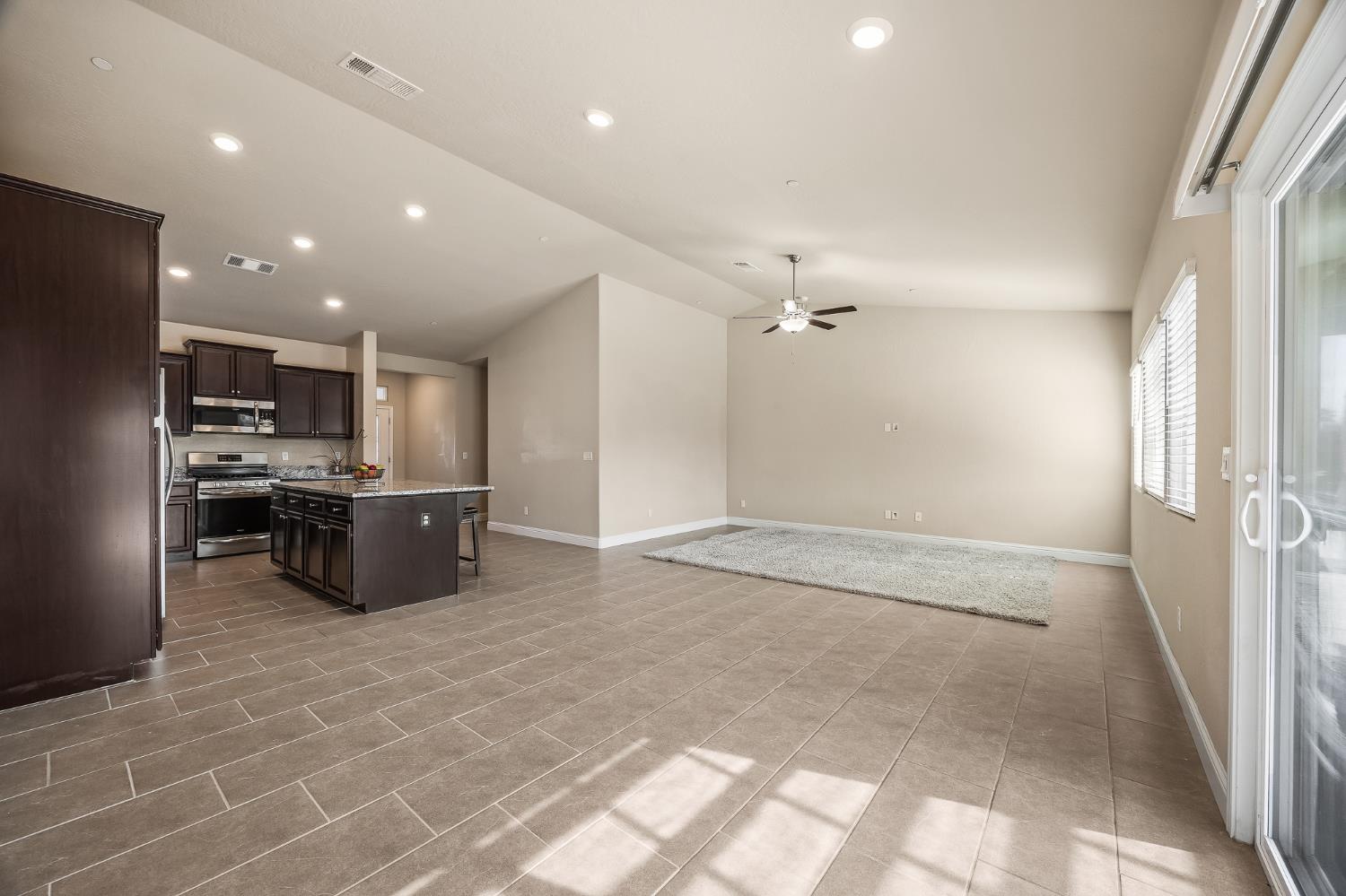 701 Strada Street Lemoore, CA 93245 - Photo 11 of 25 a large kitchen with a large counter top stainless steel appliances and cabinets