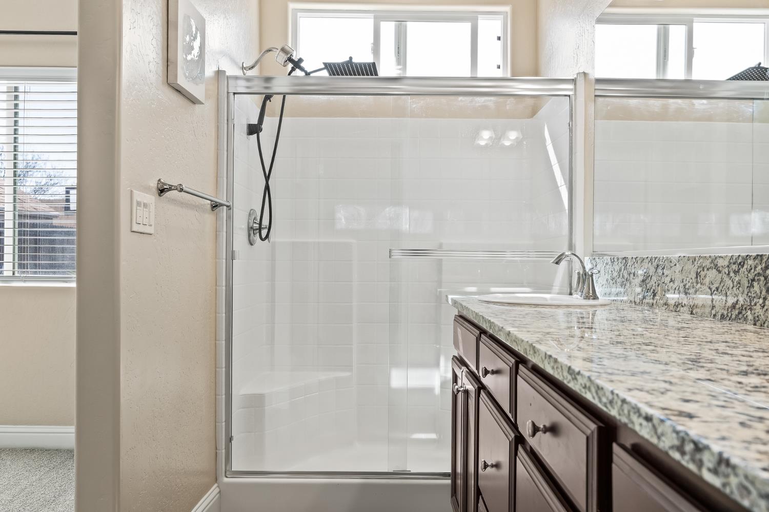701 Strada Street Lemoore, CA 93245 - Photo 15 of 25 a bathroom with a granite countertop shower a sink and vanity
