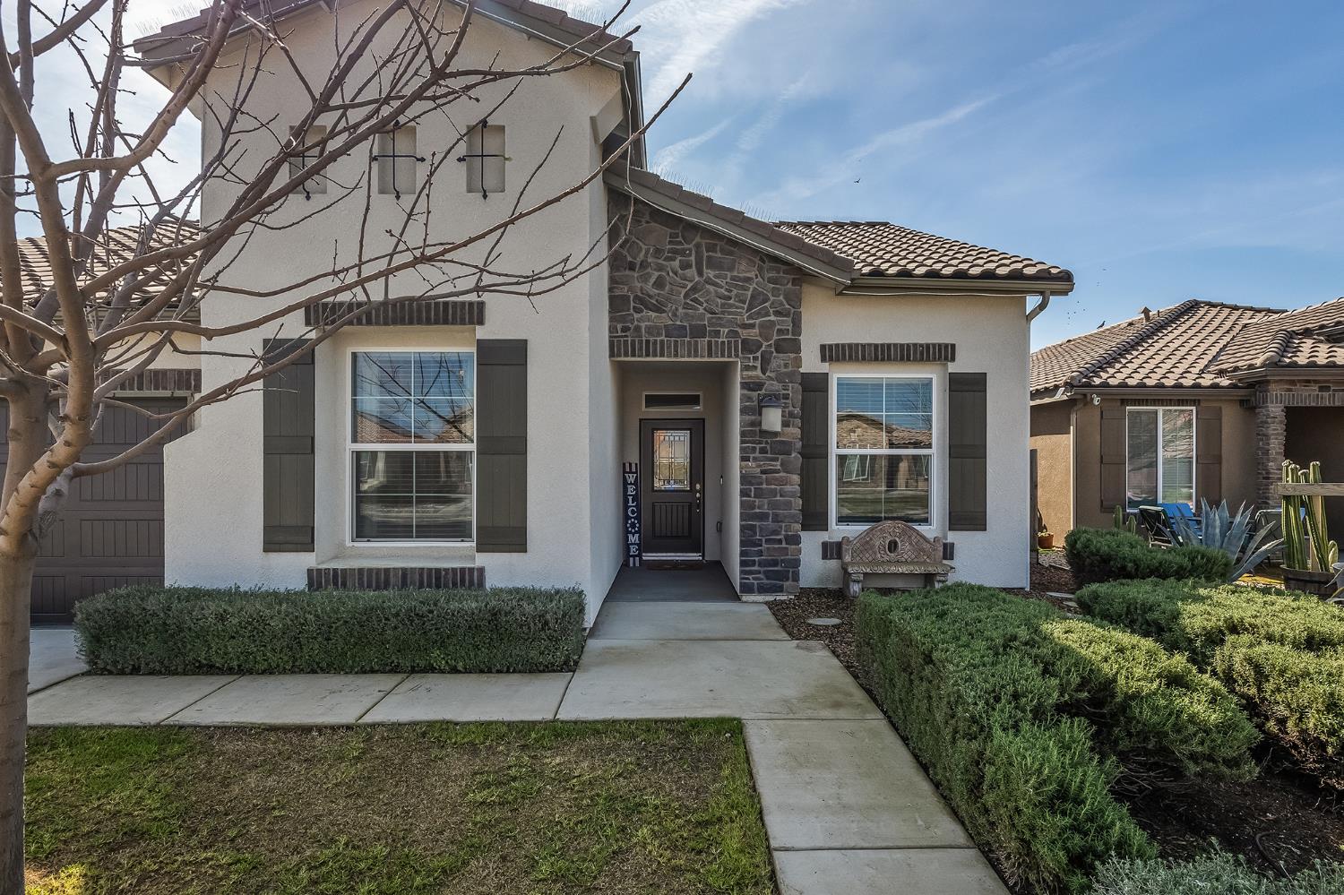 701 Strada Street Lemoore, CA 93245 - Photo 2 of 25 a front view of a house with garden