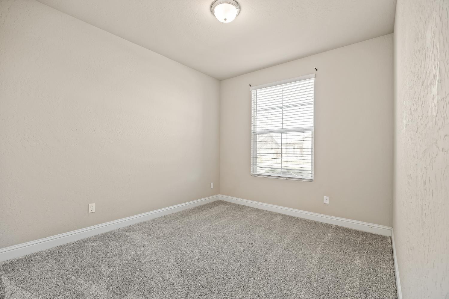 701 Strada Street Lemoore, CA 93245 - Photo 21 of 25 an empty room with a window