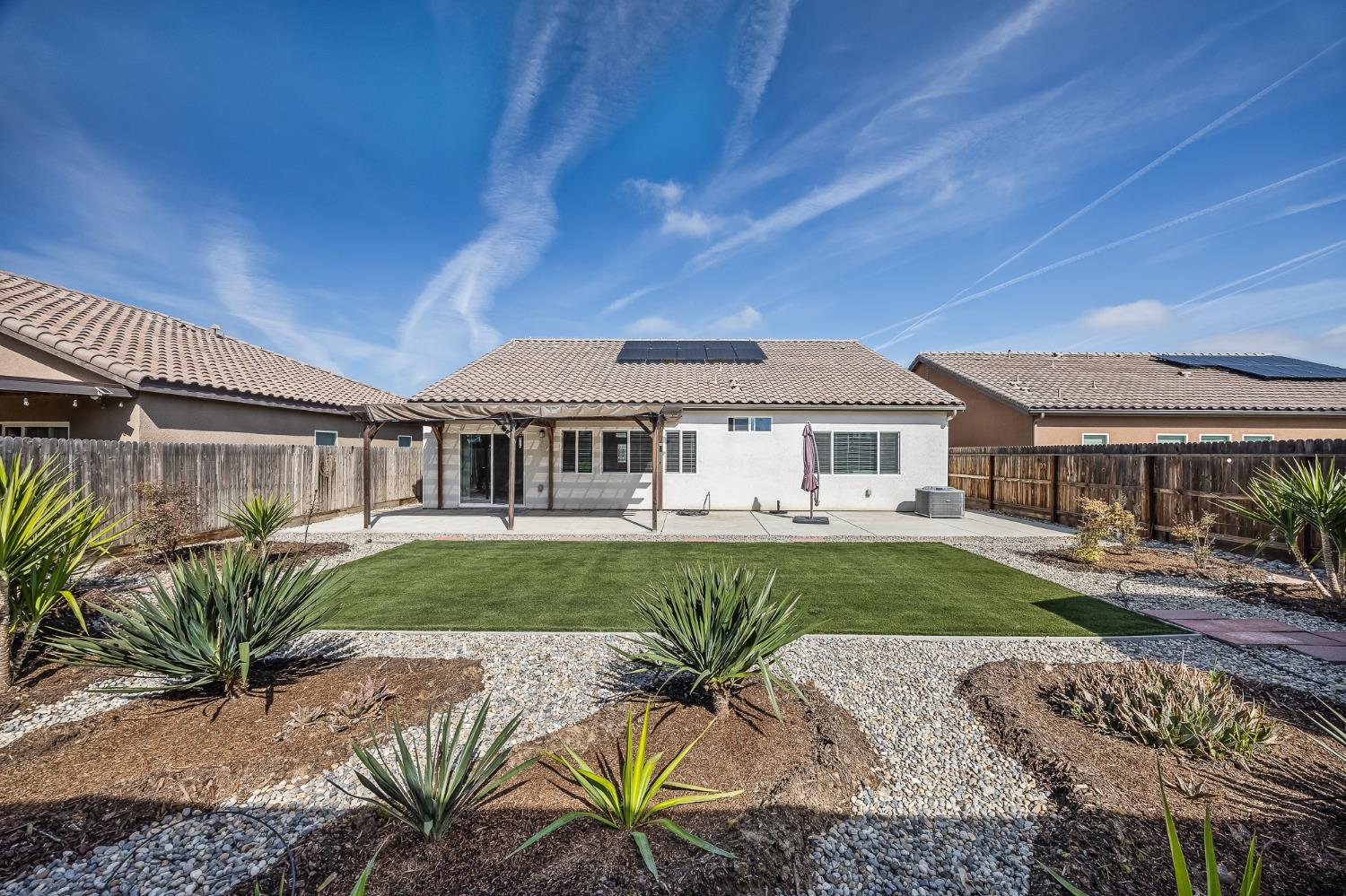 701 Strada Street Lemoore, CA 93245 - Photo 24 of 25 a view of a house with backyard and sitting area