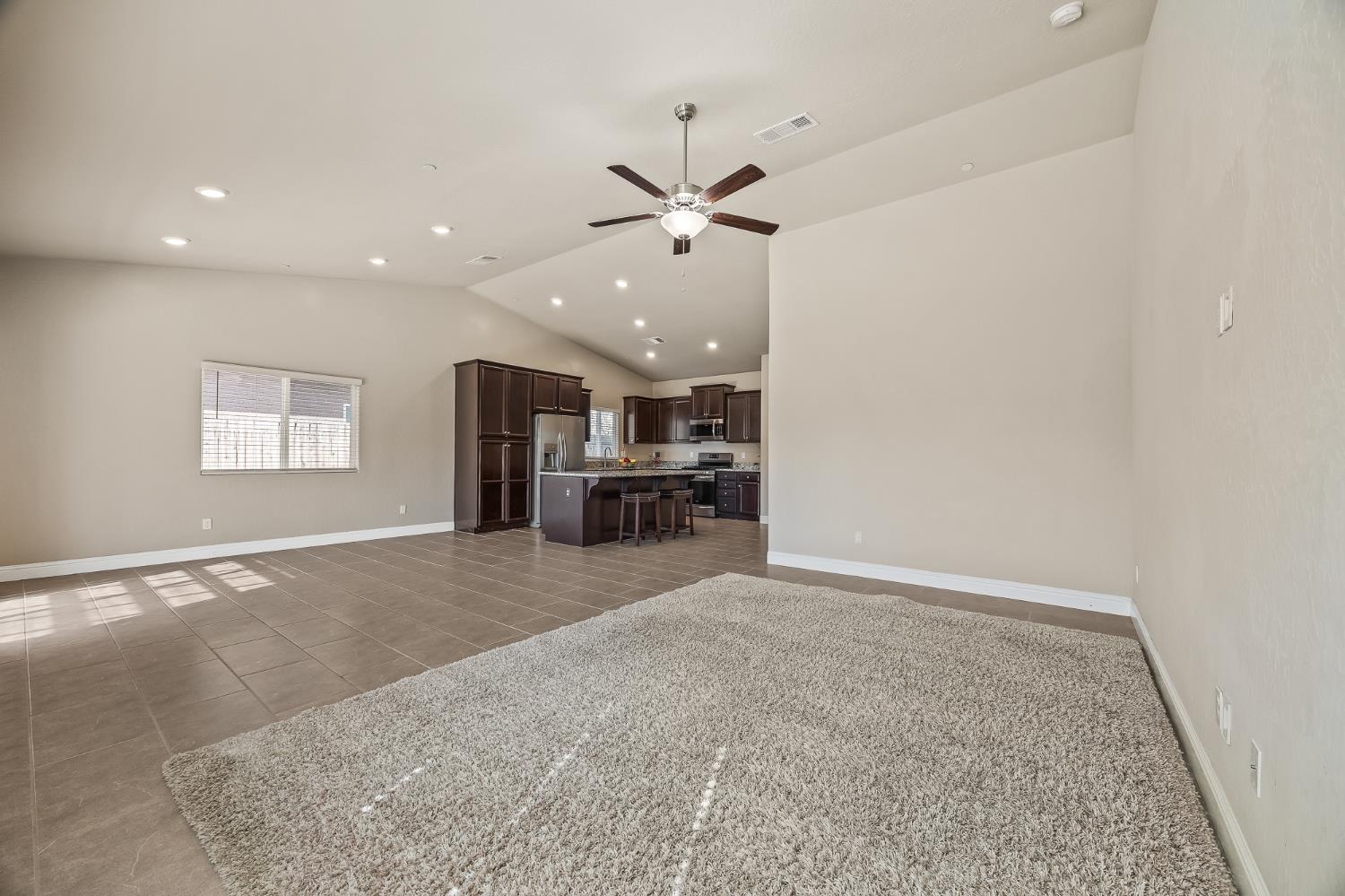 701 Strada Street Lemoore, CA 93245 - Photo 5 of 25 wooden floor in an empty room with a window