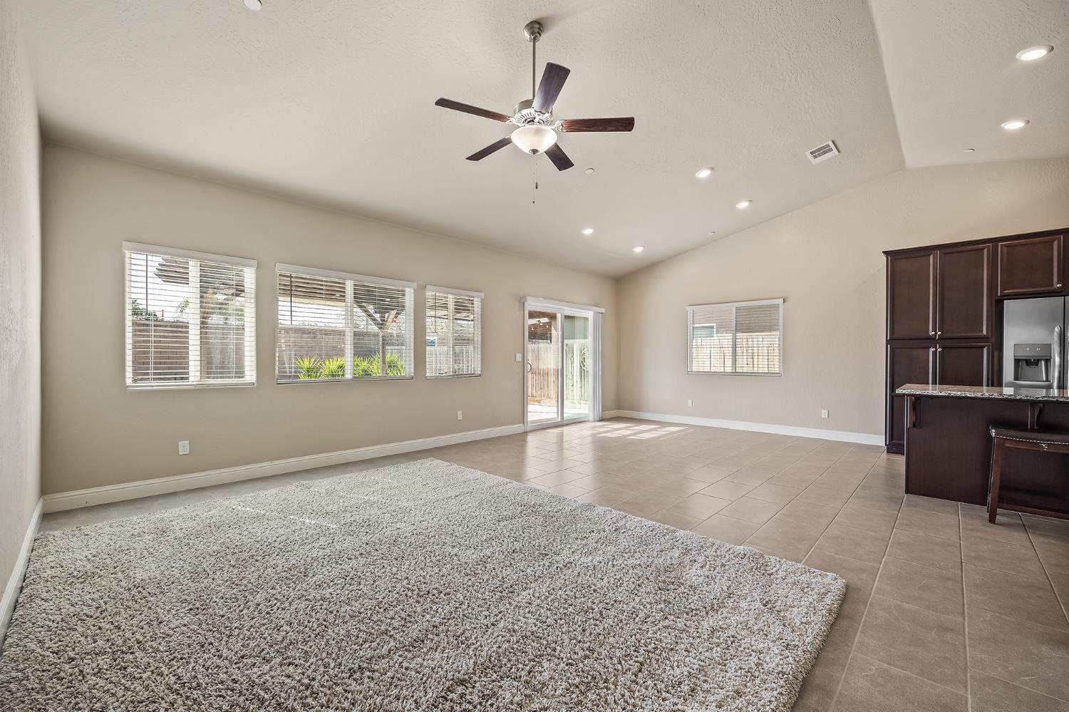 701 Strada Street Lemoore, CA 93245 - Photo 6 of 25 a view of an empty room with a window and kitchen